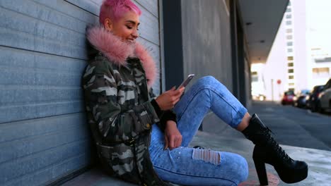 pink hair woman using mobile phone outside shop 4k