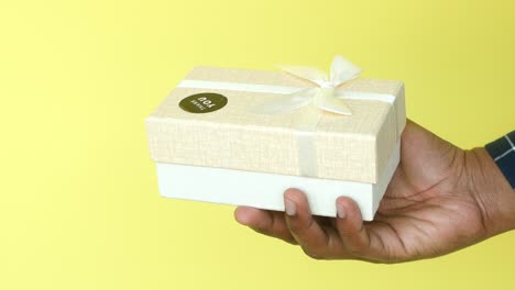 person holding a gift box with a thank you message