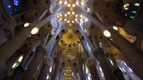 vaulted decorative ceiling of la sagrada familia cathedral in barcelona, spain - tilt down