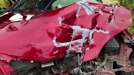 damaged red car after a collision