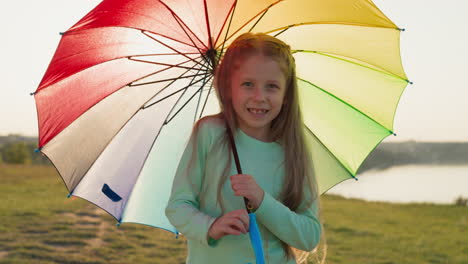 girl smiles spinning umbrella by river child umbrella creates mesmerizing pattern in air adding