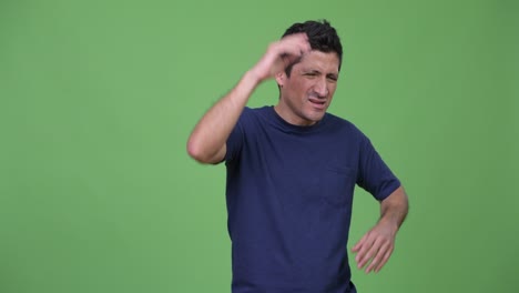 angry hispanic man gesturing and talking to camera