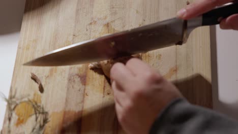 Female-Hands-Cutting-Mushrooms-With-A-Knife---High-Angle-Shot