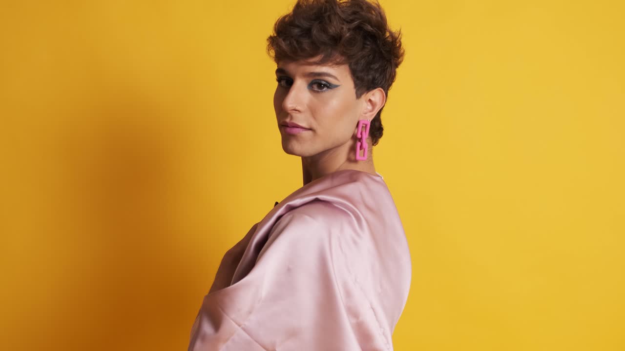 Transgender man with sensual fashion clothes posing in a photographic studio