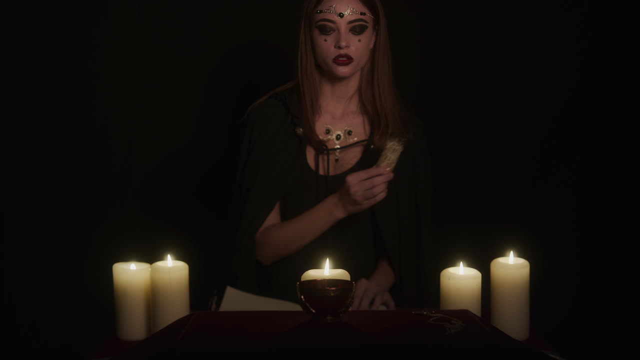 Wiccan Young Lady Witch at Altar Performs Ancient Ritual Uses Sage Incense Stick