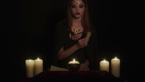 wiccan young lady witch at altar performs ancient ritual uses sage incense stick