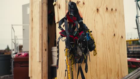 closeup of a safety climbing harness hanging on a wooden wall