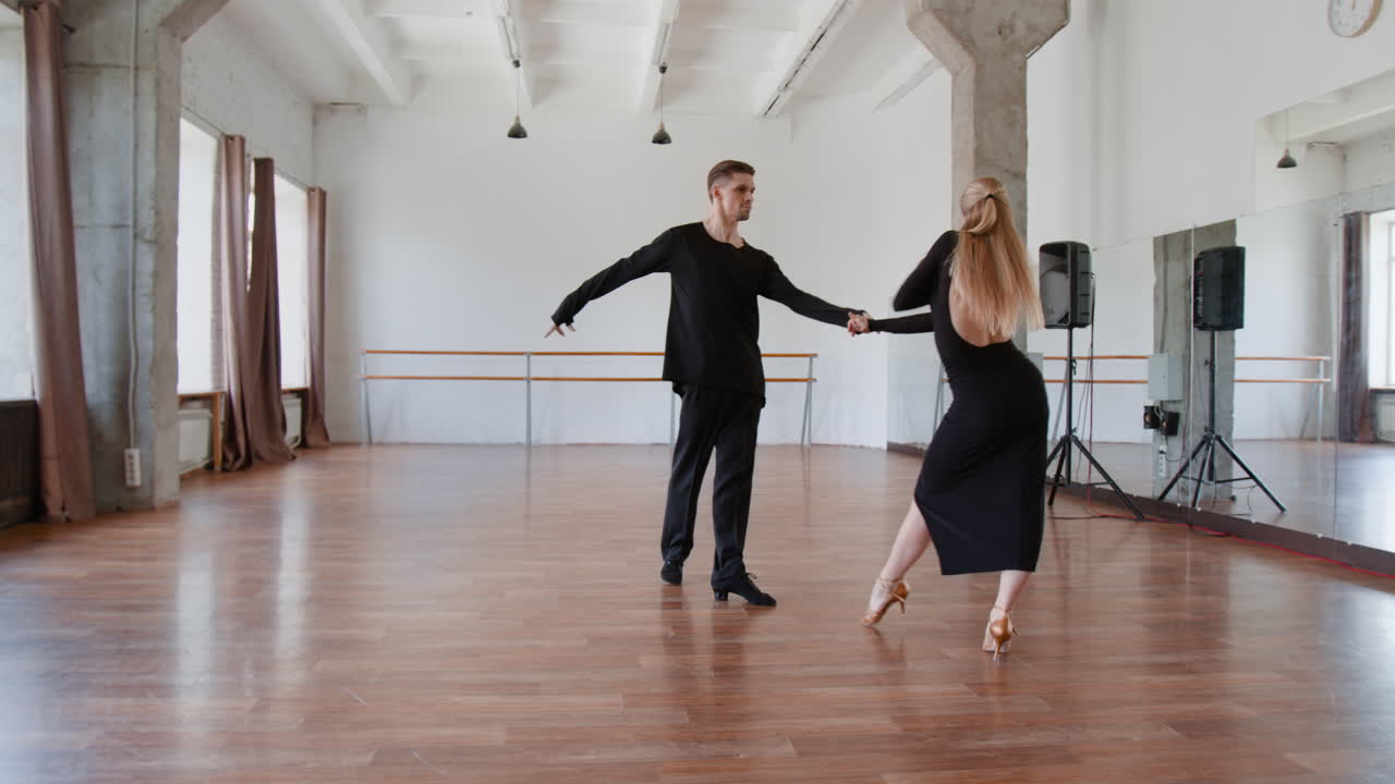 Elegant Couple Performing Ballroom Dance in Studio