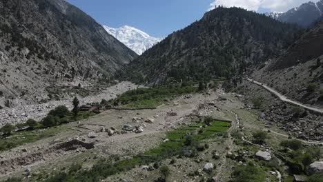 Highlands-of-Northern-Pakistan,-Aerial-View-of-Fairy-Meadows-Valley-Under-Snow-Capped-Mountain-Peaks