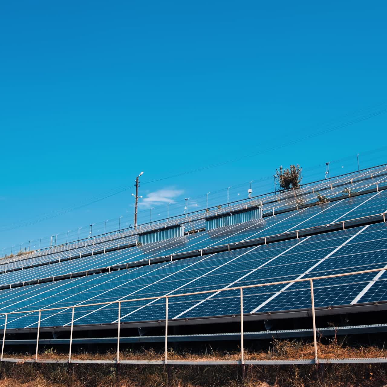New solar farm near the road. Photovoltaic panels receive ecological energy from the sun. Sustainable source of clean energy