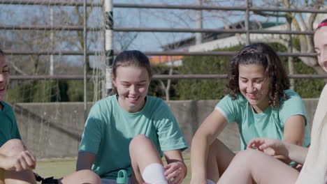 Sporty-Happy-Teenager-Girls-Having-Rest-After-Successful-Training