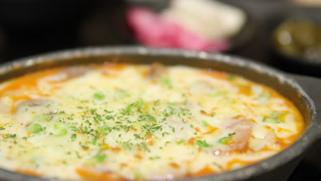 closeup of cheesy rose potato gratin on earthenware pot