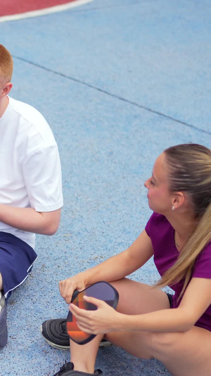 Man sitting on the ground with a ball