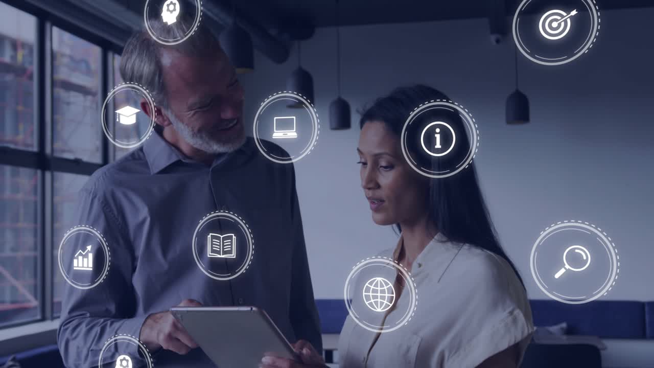 Man tapping tablet and woman tilting screen in business workspace, icons orbiting for data review