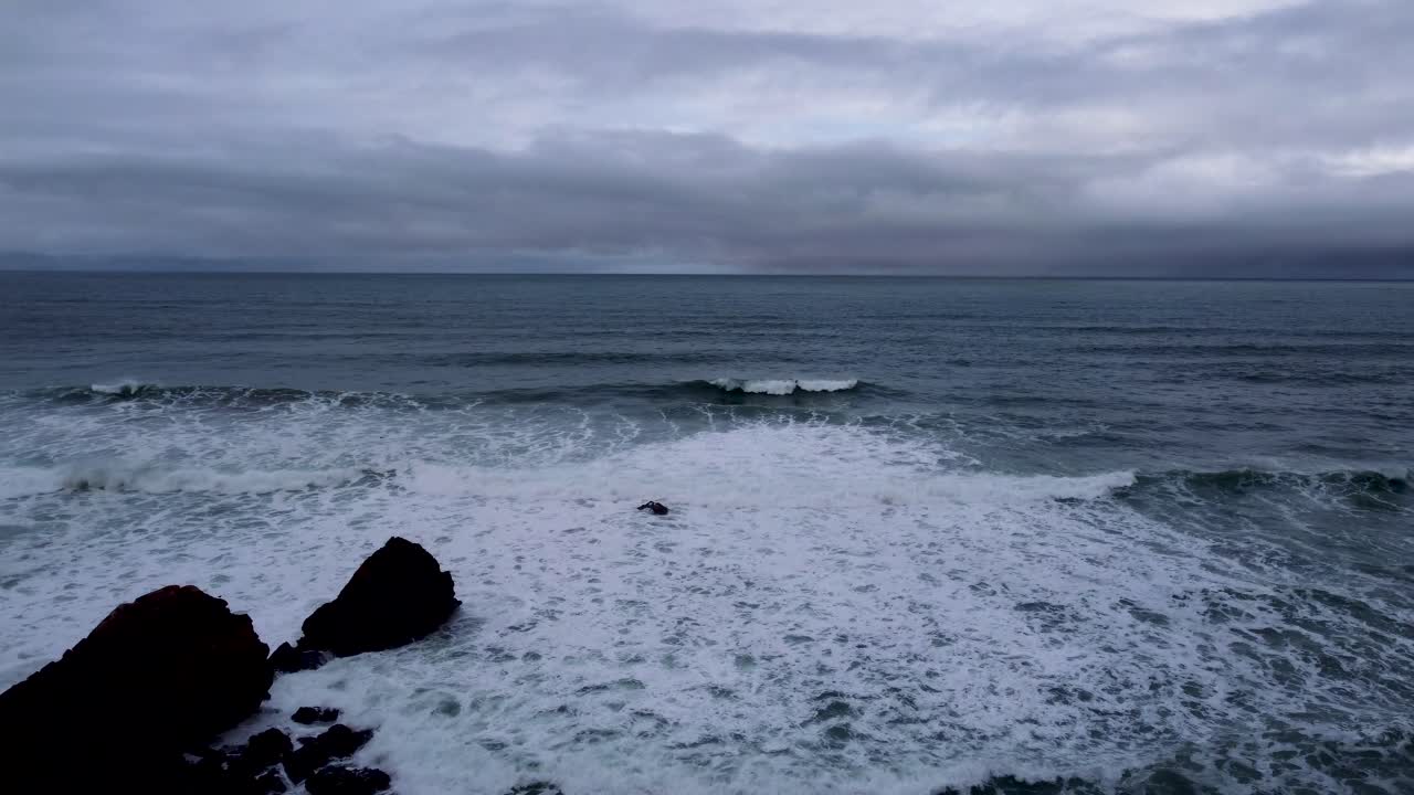 DRONE  Beautiful waves beaking. Waves crashing on the rocks, Guincho beach on the horizon. Cascais, Portugal. Aerial view winter coastal ocean line. The Atlantic Ocean near Cabo da Roca