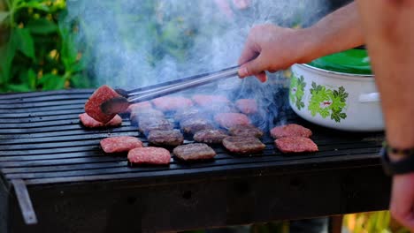 cooked-meatballs-are-turning-with-tongs