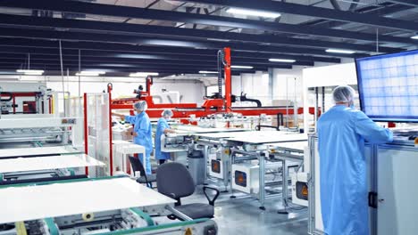 modern industry with workers inside. specialists control the work of automated equipment on big screen of monitors.
