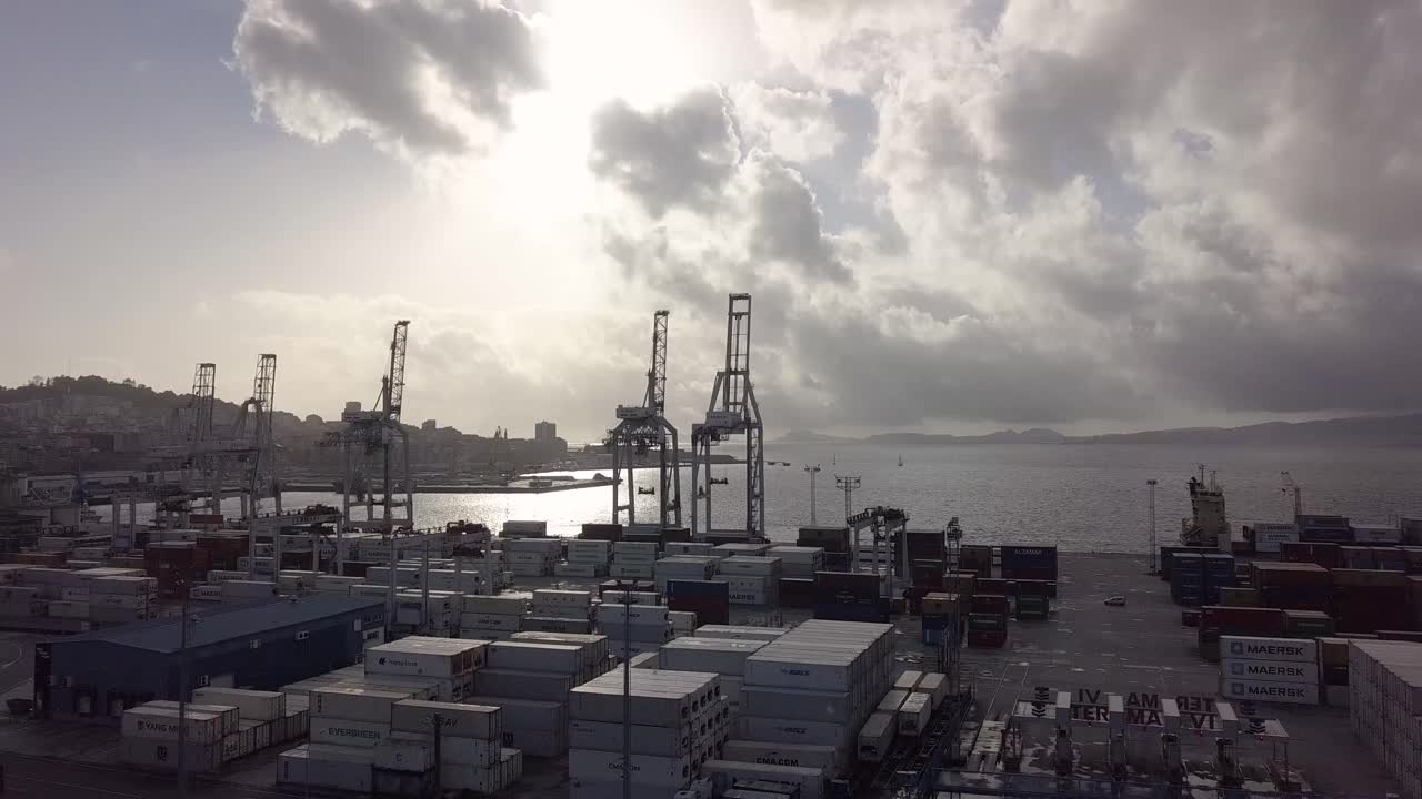 Aerial view of the important port of Vigo at sunset with the cranes are in silhouette while lock down of the pandemic of covid 19