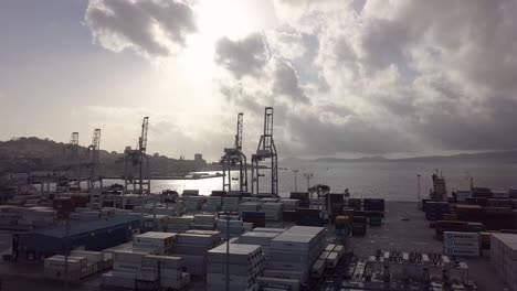 aerial view of the important port of vigo at sunset with the cranes are in silhouette while lock down of the pandemic of covid 19