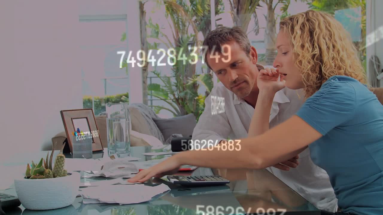 Woman reaching for calculator, man helping, entering numbers amid bills, overlay showing totals