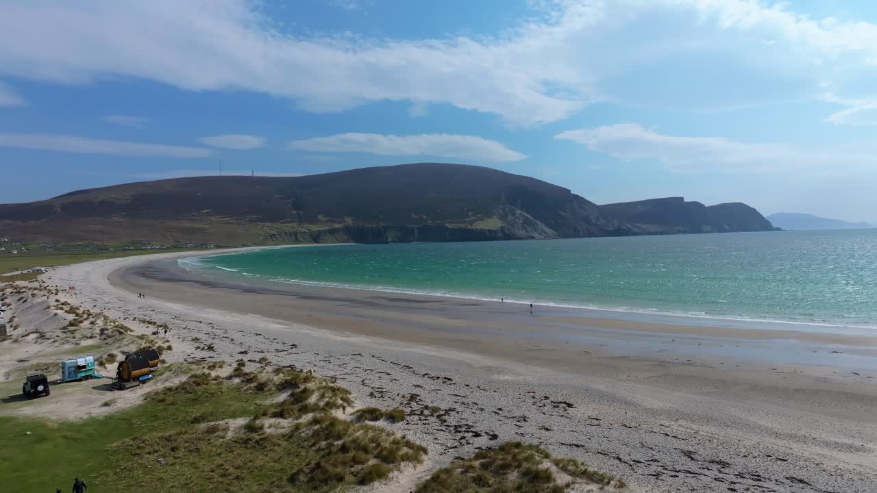 4K cinematic drone footage of Keel Beach on Achill Island, County Mayo, showcasing a long sandy shoreline, rolling waves, and dramatic cliffs along the Wild Atlantic Coast. Ireland_07