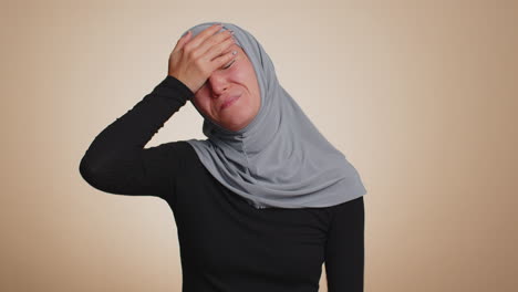 young muslim woman loses becoming surprised by lottery results, bad fortune, loss, unlucky news