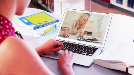 Caucasian-female-teacher-using-laptop-on-video-call-with-female-student