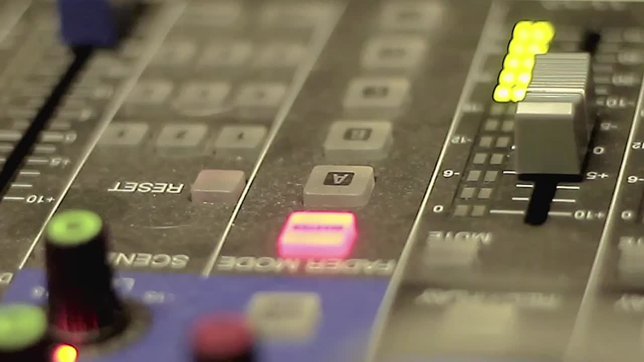 professional music mixing desk close-up audio control panel faders knobs with led lights studio equipment sound engineering with no people stock footage stock video