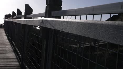 Empty-wooden-bridge-with-railings-wide-crane-shot