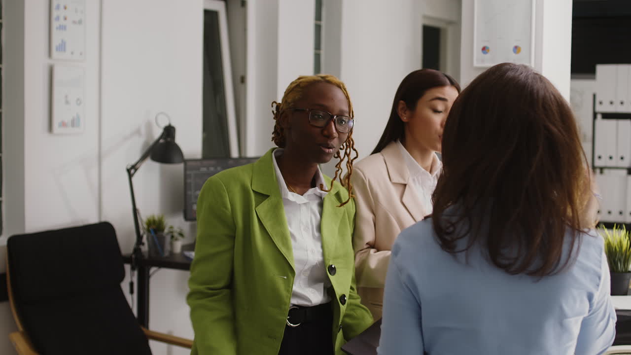 Two business women discussing work in an office