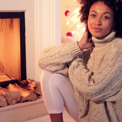 Woman-smiles-at-camera-while-wearing-sweater