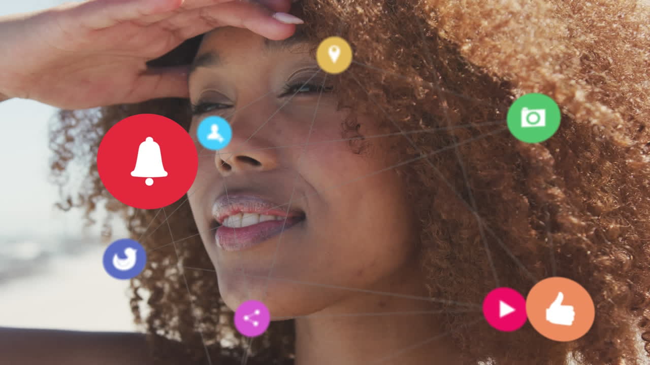 Animation of network of social media digital icons over smiling woman on beach