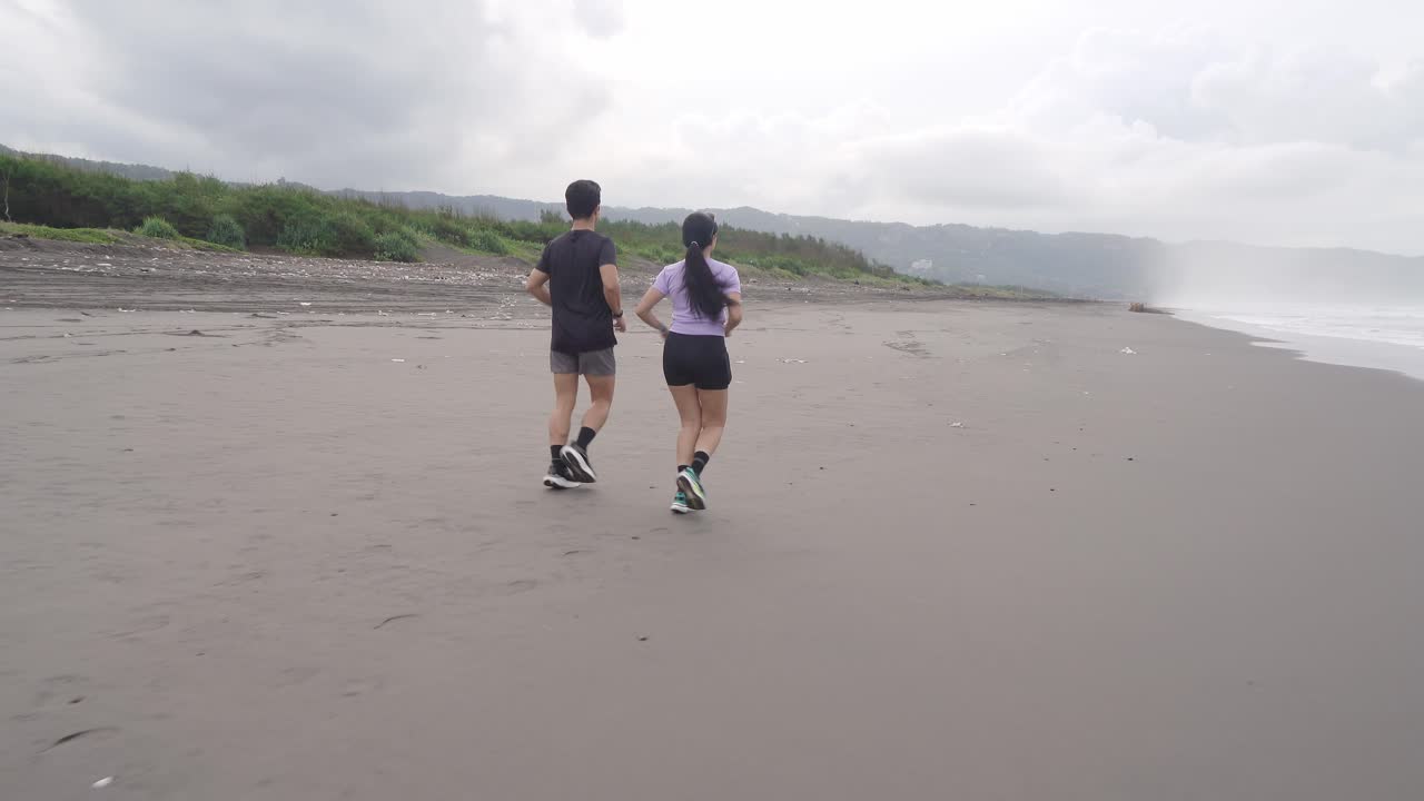 Couple Running on a Beach