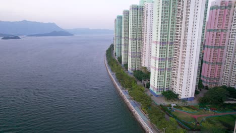 tall apartment buildings with sweeping views of sha tin hoi and the high mountains in the background and artificial gardens in hong kong's ultra-modern ma on shan