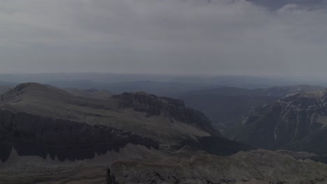 this drone video features a stunning frontal descriptive shot flying over the majestic mountains of pico del castillo d’acher in the aragonese pyrenees, spain, showcasing breathtaking natural beauty.
