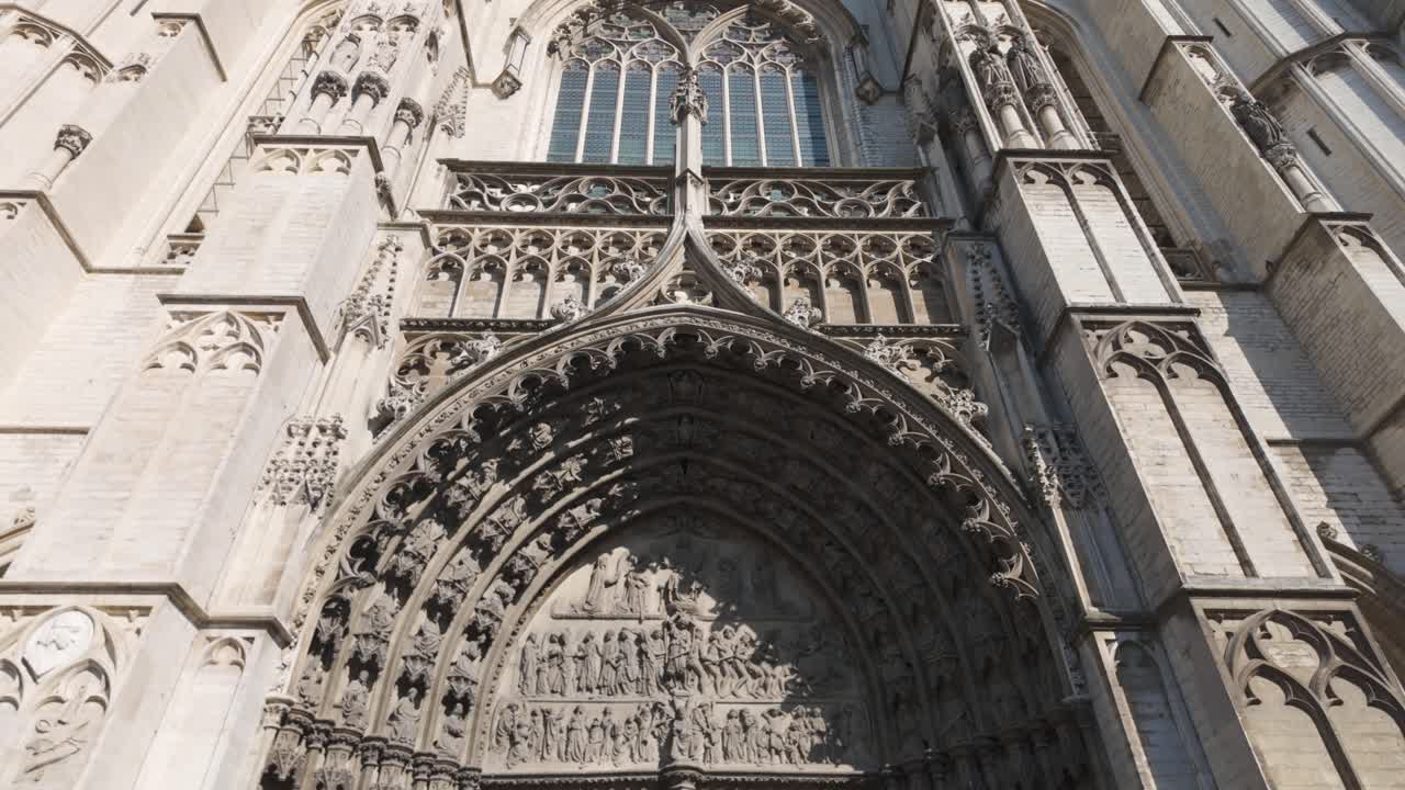Gothic Cathedral of Our Lady entrance with detailed stone carvings and large double doors in Antwerp