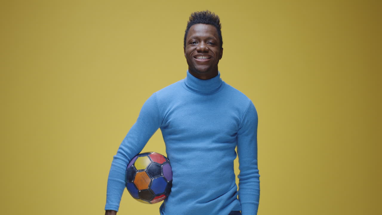 Man holding a colorful soccer ball