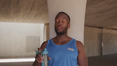 man training in an urban setting taking a break