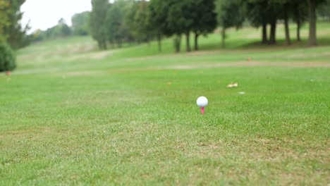 shot from behind the player as he takes a tee shot