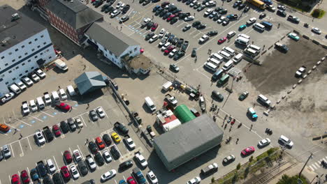 timelapse drone birds-eye view of workers leaving bath iron works in maine