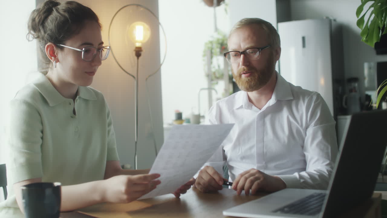 Financial Consultant Discussing Papers with Woman