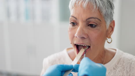 doctor examining patient's mouth