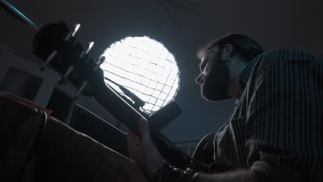 man playing guitar in a home studio