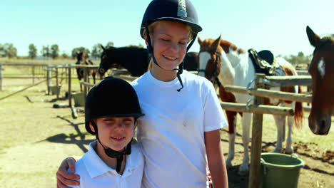 siblings standing with arm around in the ranch on a sunny day 4k