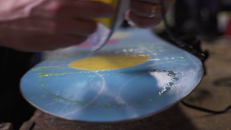 melting hot wax onto the base of a snowboard