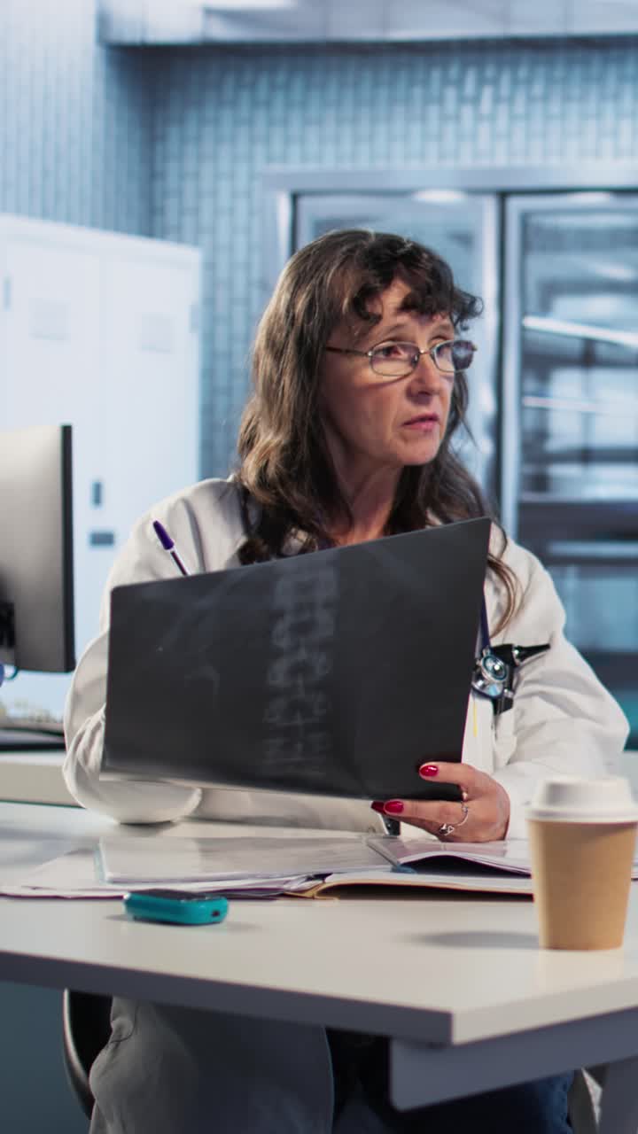 Doctor reviewing X-ray of spine