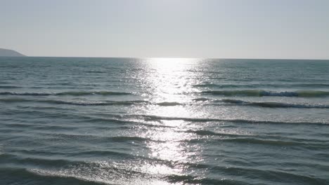 aerial shot of sea waves in slow motion on surface on a summer day