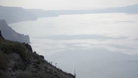 Wind-blowing-the-water-inside-a-volcano's-caldera-in-Santorini,-Greece