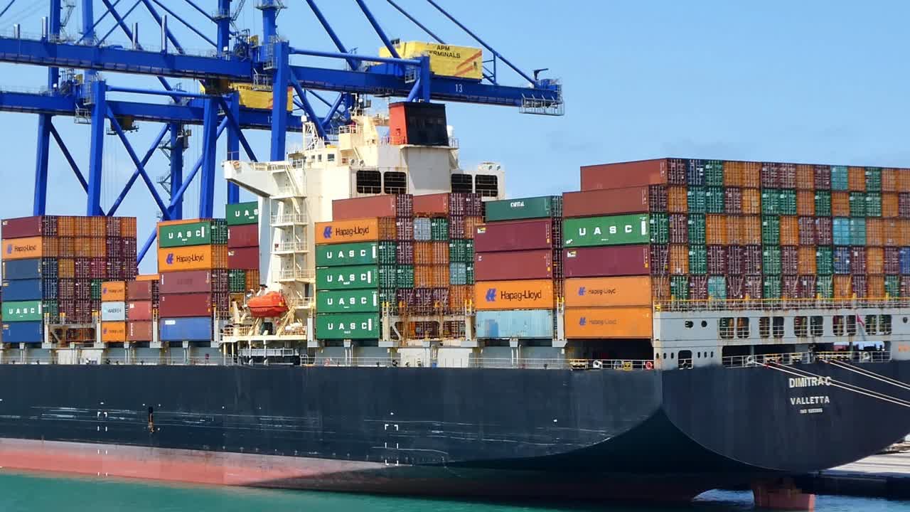 Large cargo ship carrying containers in the port of Valencia, Spain