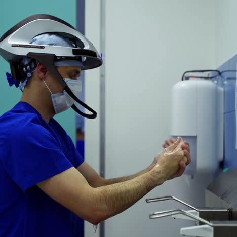 surgeon washing hands with soap. doctor in surgical cap and mask disinfects his hands. surgical hand disinfection. hygiene before operation in clinic.